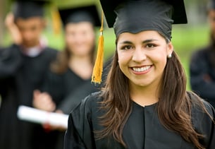 graduation group of students with a woman leading smiling